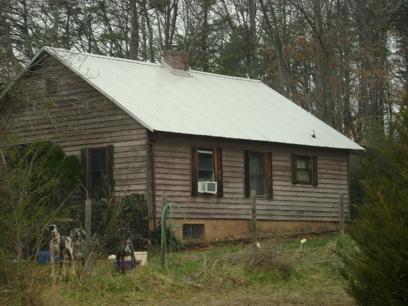 White metal roof on an old wood sided farmhouse, from a Metal Roof Installation job in Buena Park